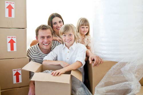 Packed boxes and furniture ready for transport by removals team